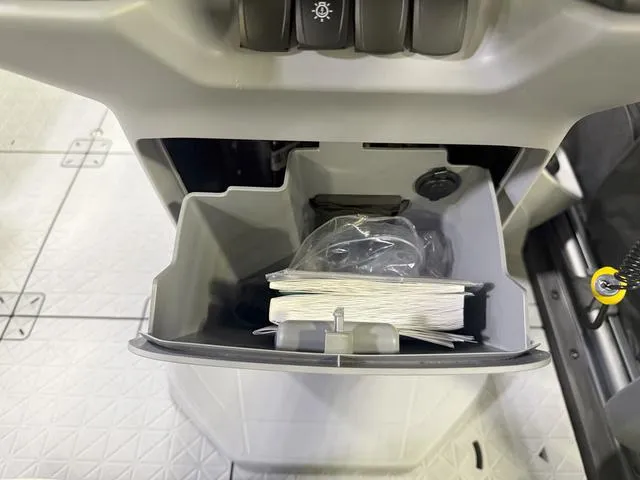 Slide: The Image of Storage compartment of 2025 Sea-Doo Switch™ Fish 18, featuring organized space and controls. - 11