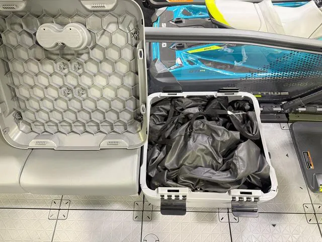Slide: The Image of 2025 Sea-Doo Switch™ Fish 18 storage compartment with hexagonal lid and black cover. - 17