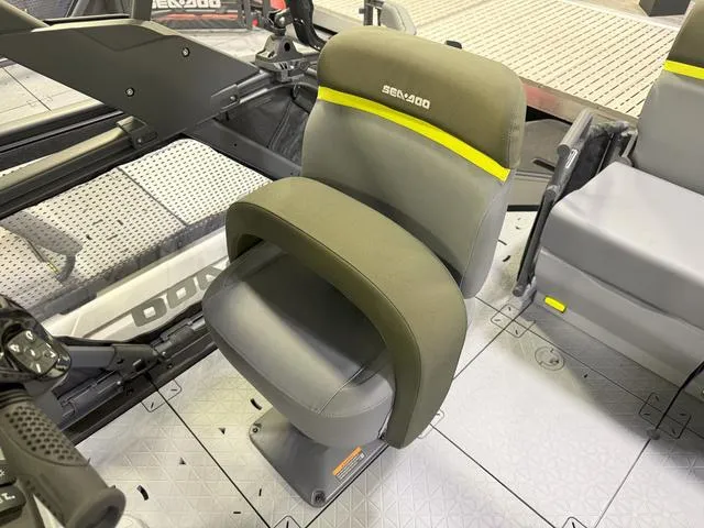 Slide: The Image of 2025 Sea-Doo Switch Fish 18 seat, gray with yellow accents, on a textured deck. - 8