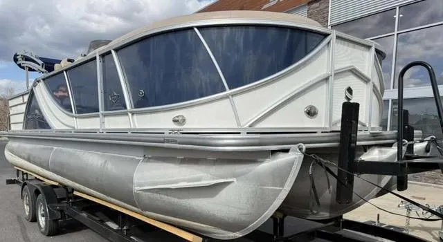 Slide: The Image of 2016 South Bay 523FCR 2.75 pontoon boat on trailer, sleek design, large windows. - 2