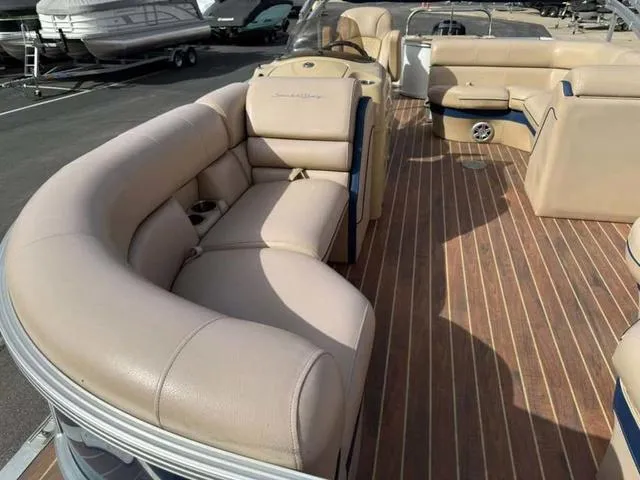 Slide: The Image of 2016 South Bay 523FCR 2.75 pontoon boat with beige seating and wood-style flooring. - 5
