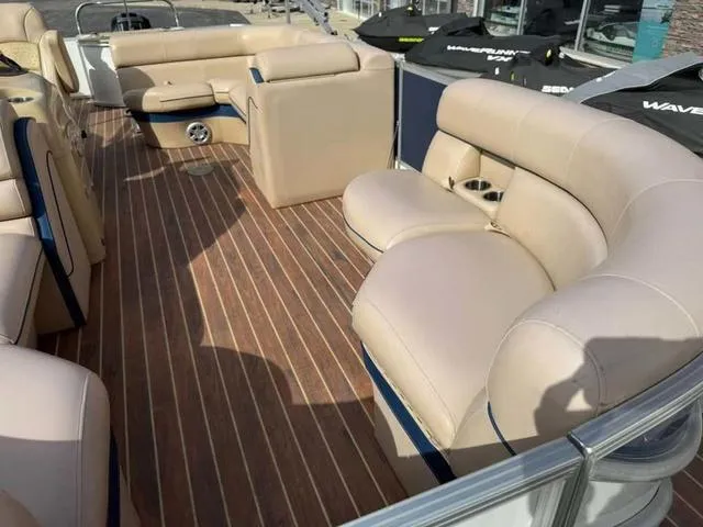 Slide: The Image of Luxurious 2016 South Bay 523FCR 2.75 pontoon boat with plush seating and wood-style flooring. - 6