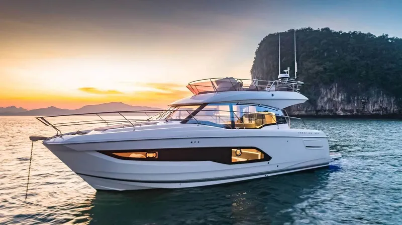 The Image of 2024 Prestige 420 Fly yacht at sunset near a rocky island. - 0