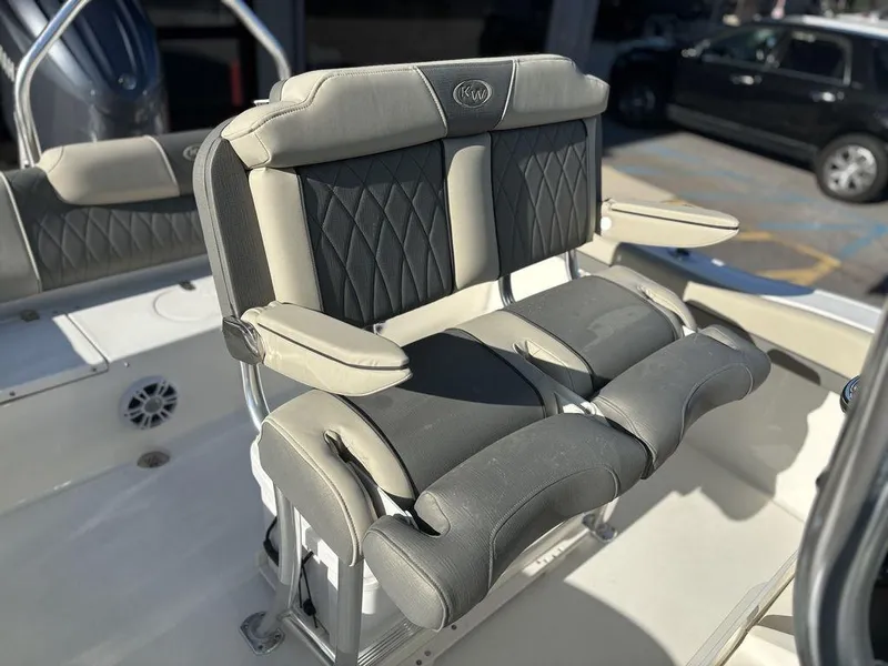Slide: The Image of 2025 Key West 219 FS boat seating with cushioned armrests and backrests. - 13