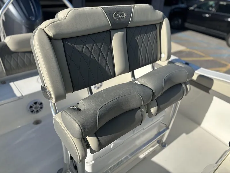 Slide: The Image of 2025 Key West 219 FS boat seating with cushioned backrest and armrests. - 14