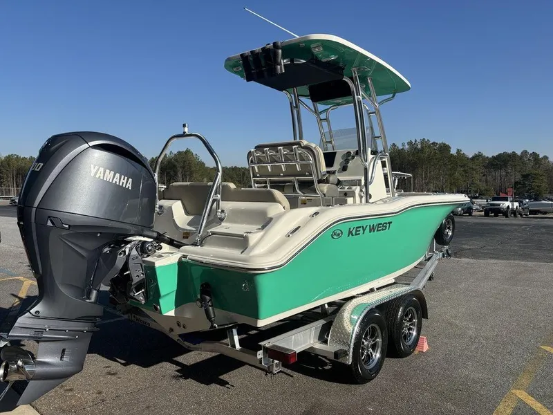 Slide: The Image of 2025 Key West 219 FS boat with Yamaha engine on a trailer, parked outdoors. - 3