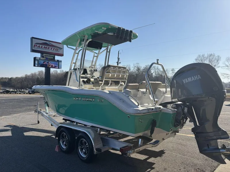 Slide: The Image of 2025 Key West 219 FS boat on trailer with Yamaha engine, parked outdoors. - 5