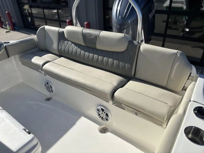 Slide: The Image of 2025 Key West 219 FS boat interior with cushioned seating and speakers. - 8