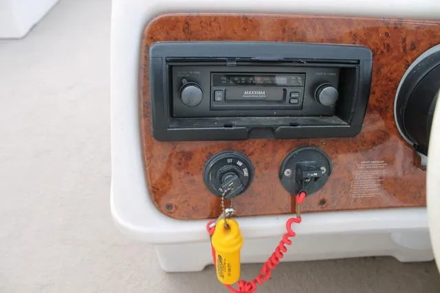 Slide: The Image of Dashboard of a 2002 Harris Cruiser 200 boat with radio and ignition controls. - 11