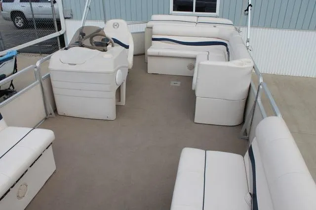 Slide: The Image of 2002 Harris Cruiser 200 pontoon boat interior with white seating and steering console. - 8