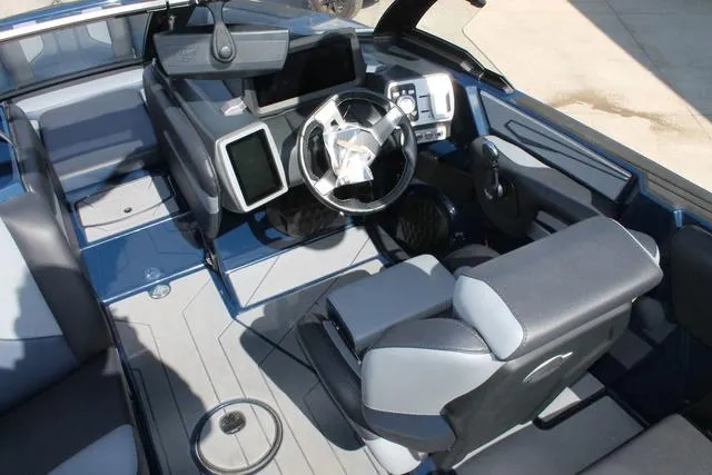 Slide: The Image of 2023 Malibu 21 LX boat interior with modern dashboard and seating. - 12