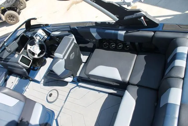 Slide: The Image of 2023 Malibu 21 LX boat interior with modern seating and sleek dashboard design. - 8