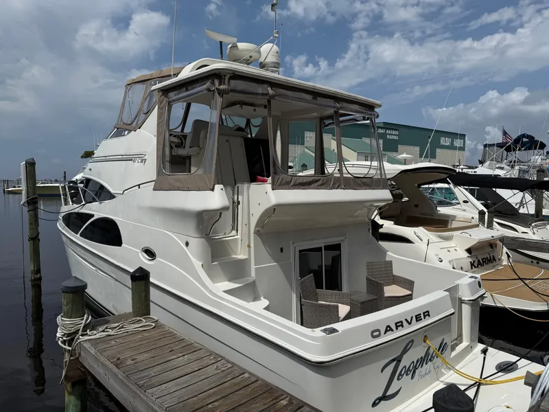 Slide: The Image of 2005 Carver 41 Cockpit Motor Yacht docked at marina under cloudy sky. - 17