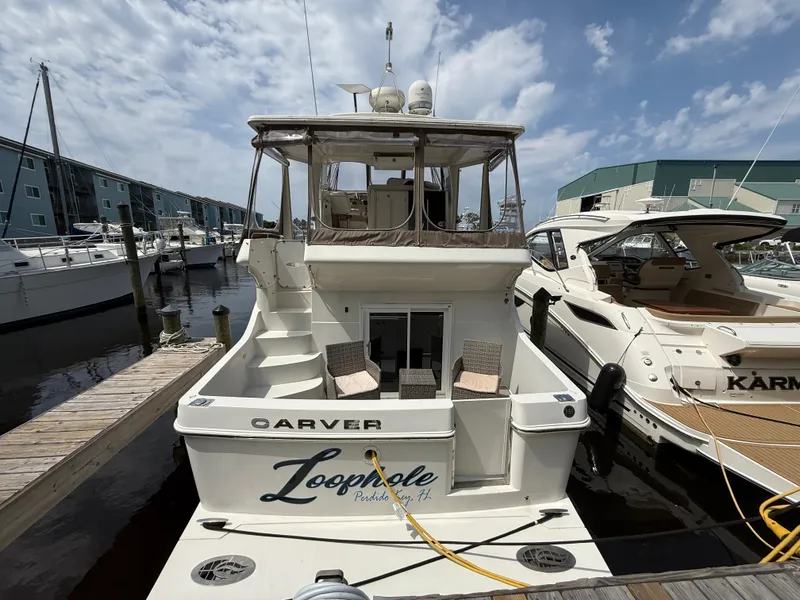 Slide: The Image of 2005 Carver 41 Cockpit Motor Yacht docked at marina under cloudy sky. - 6