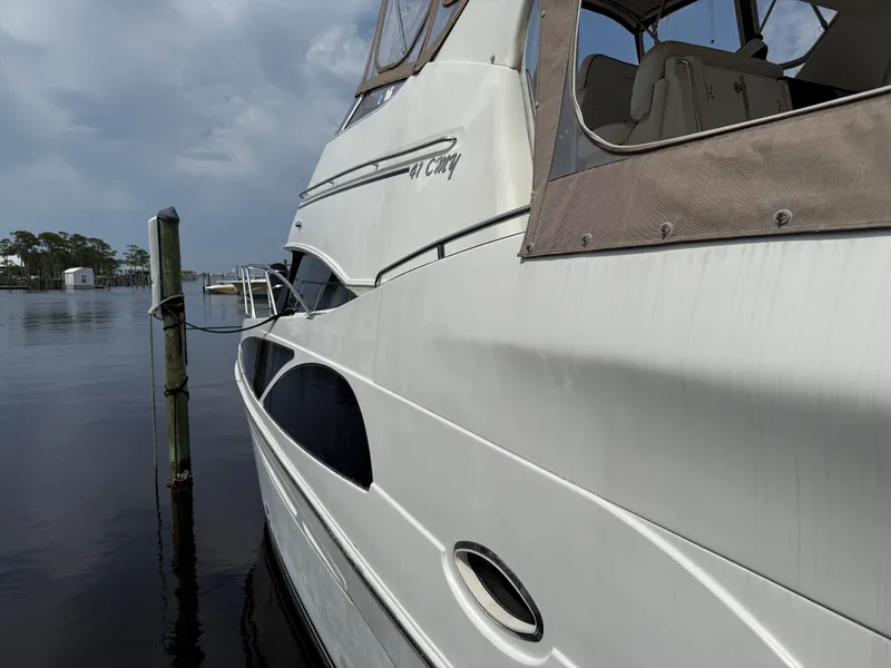 Slide: The Image of 2005 Carver 41 Cockpit Motor Yacht docked on a calm, cloudy day. - 7