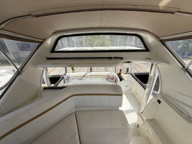 Slide: The Image of Interior view of 2005 Carver 41 Cockpit Motor Yacht with white seating and large windows. - 8