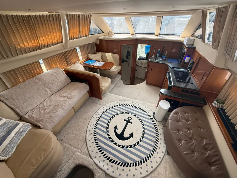 Slide: The Image of Luxurious interior of 2005 Carver 41 Cockpit Motor Yacht with cozy seating and nautical decor. - 9