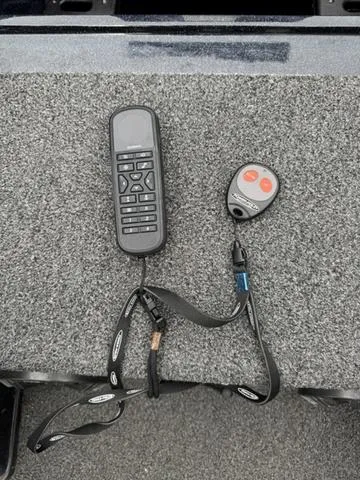 Slide: The Image of Remote controls on a Tracker Nitro Z19 boat, 2021 model, on a textured surface. - 10