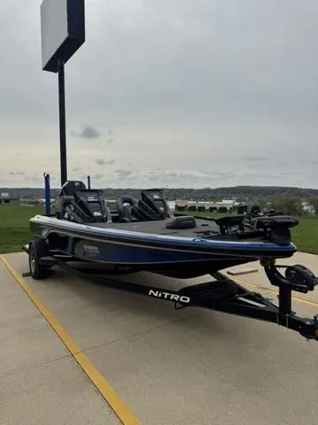 Slide: The Image of 2021 Tracker Nitro Z19 boat parked outdoors on a cloudy day. - 6