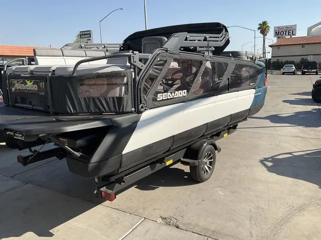 Slide: The Image of 2024 Sea-Doo Switch® Cruise 21 - 230 hp pontoon boat on trailer in parking lot. - 5