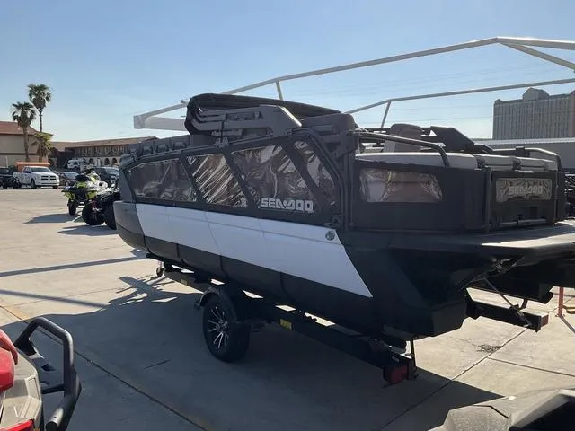 Slide: The Image of 2024 Sea-Doo Switch® Cruise 21 - 230 hp pontoon boat on trailer in sunny parking lot. - 7