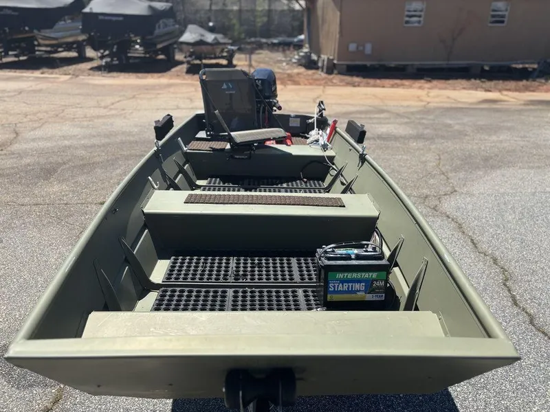 Slide: The Image of 2024 Lowe L1240 Jon boat with battery on deck, parked outdoors. - 10