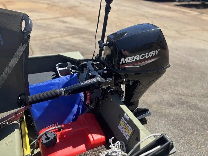 Slide: The Image of 2024 Lowe L1240 Jon boat with Mercury outboard motor, featuring a red fuel tank. - 7