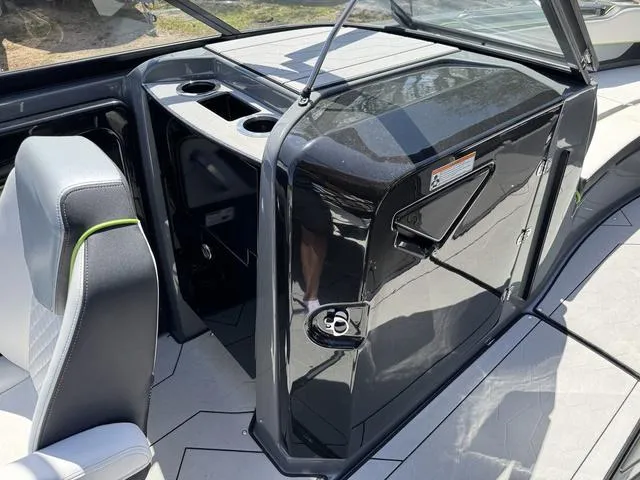 Slide: The Image of 2021 Yamaha Boats 255XD interior with sleek black console and seating. - 10