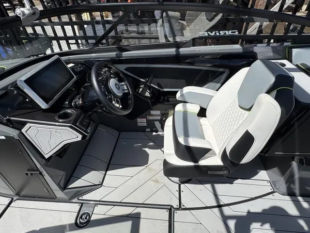 Slide: The Image of 2021 Yamaha Boats 255XD cockpit with modern steering, touchscreen, and comfortable seating. - 11