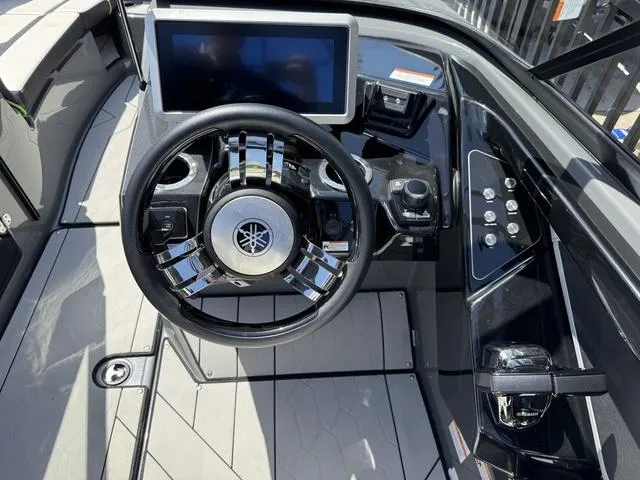 Slide: The Image of Steering wheel and dashboard of 2021 Yamaha Boats 255XD, featuring modern controls and display. - 13