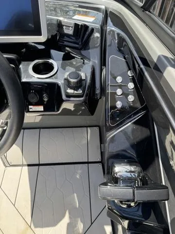 Slide: The Image of 2021 Yamaha Boats 255XD dashboard with controls and touchscreen display. - 14