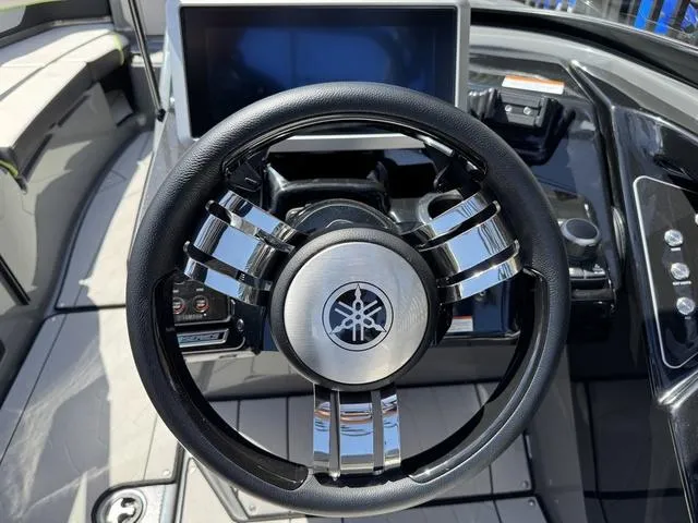 Slide: The Image of Steering wheel of 2021 Yamaha Boats 255XD, featuring sleek design and modern dashboard. - 15