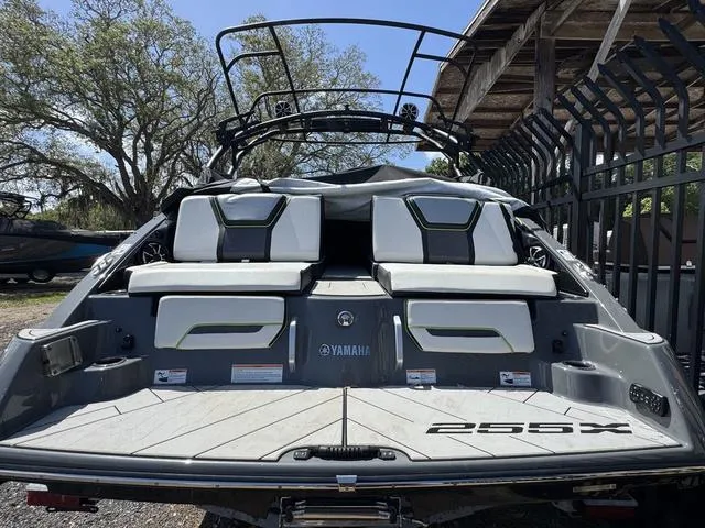 Slide: The Image of 2021 Yamaha Boats 255XD, rear view, showcasing sleek design and seating area. - 2