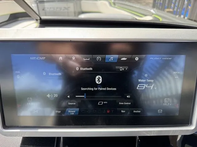 Slide: The Image of Touchscreen display of a 2021 Yamaha Boats 255XD, showing Bluetooth and water temperature settings. - 20