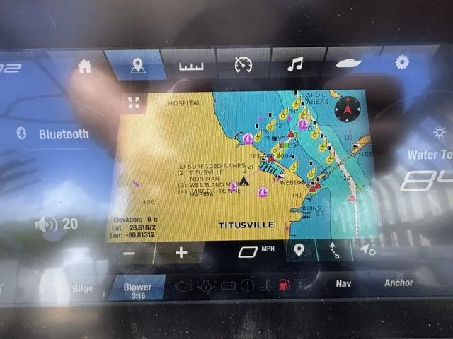 Slide: The Image of Navigation display on a 2021 Yamaha Boats 255XD, showing a map of Titusville area. - 22