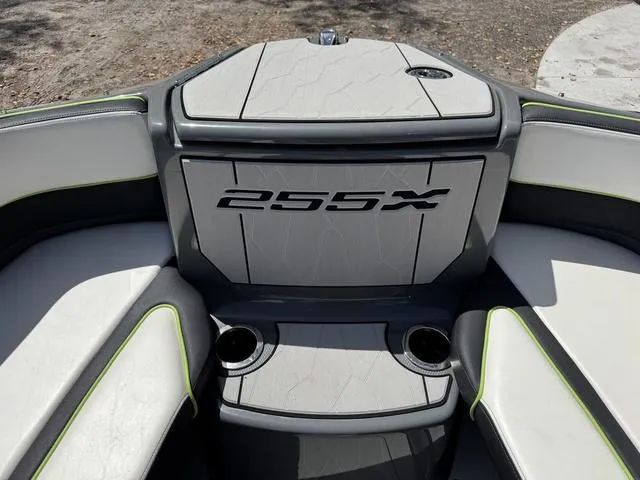 Slide: The Image of 2021 Yamaha Boats 255XD interior with seating and cup holders, featuring sleek design. - 24