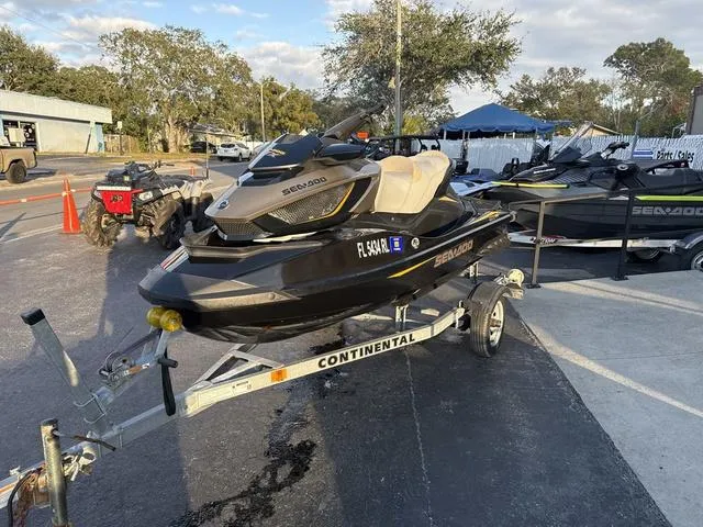 Slide: The Image of 2017 Sea-Doo GTX Waverunner on trailer, parked outdoors in a lot. - 7