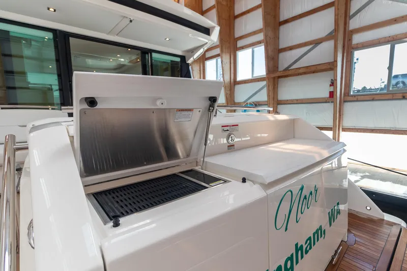 Slide: The Image of 2023 Tiara Yachts C44 Coupe with outdoor grill in a wooden boathouse. - 10
