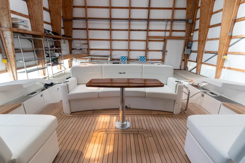 Slide: The Image of 2023 Tiara Yachts C44 Coupe interior with elegant seating and wooden table. - 14