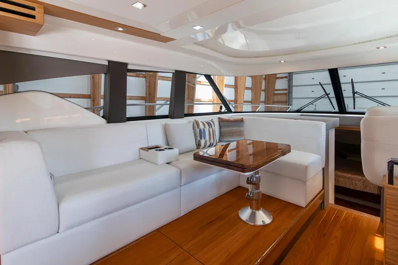 Slide: The Image of Luxurious interior of 2023 Tiara Yachts C44 Coupe with elegant seating and wooden table. - 17