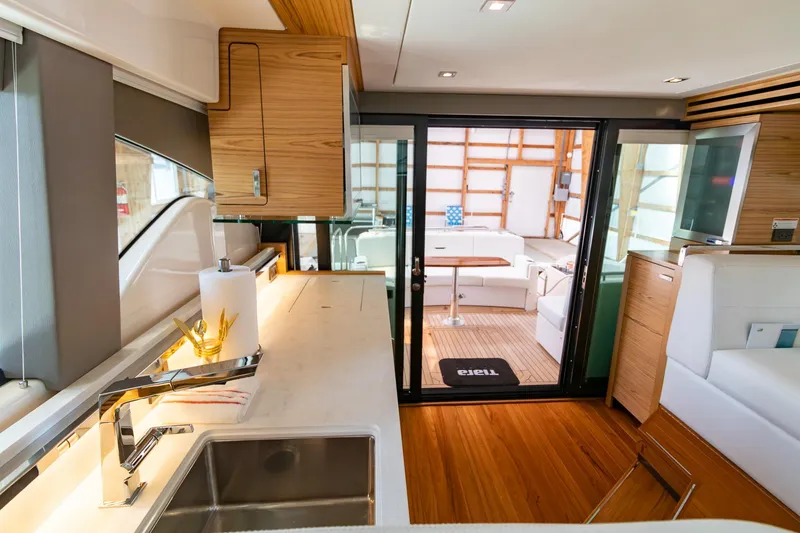 Slide: The Image of 2023 Tiara Yachts C44 Coupe interior with modern kitchen and spacious seating area. - 19