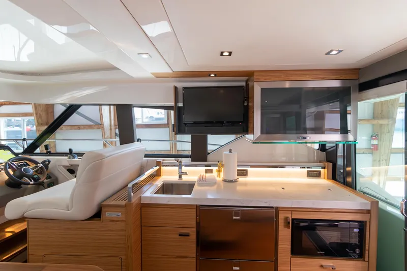 Slide: The Image of Luxurious interior of 2023 Tiara Yachts C44 Coupe with modern kitchen and helm station. - 21