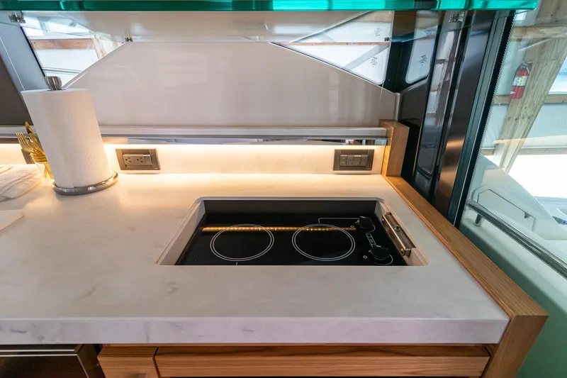 Slide: The Image of Modern kitchen area in 2023 Tiara Yachts C44 Coupe with sleek induction cooktop. - 22