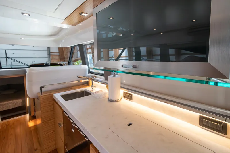 Slide: The Image of Modern kitchen interior of 2023 Tiara Yachts C44 Coupe with sleek countertops and ample lighting. - 24