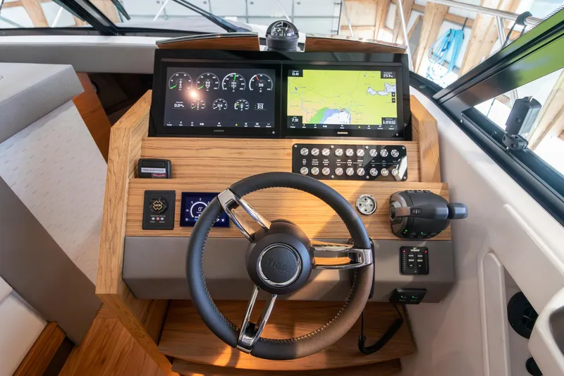 Slide: The Image of 2023 Tiara Yachts C44 Coupe helm with modern navigation and control systems. - 25