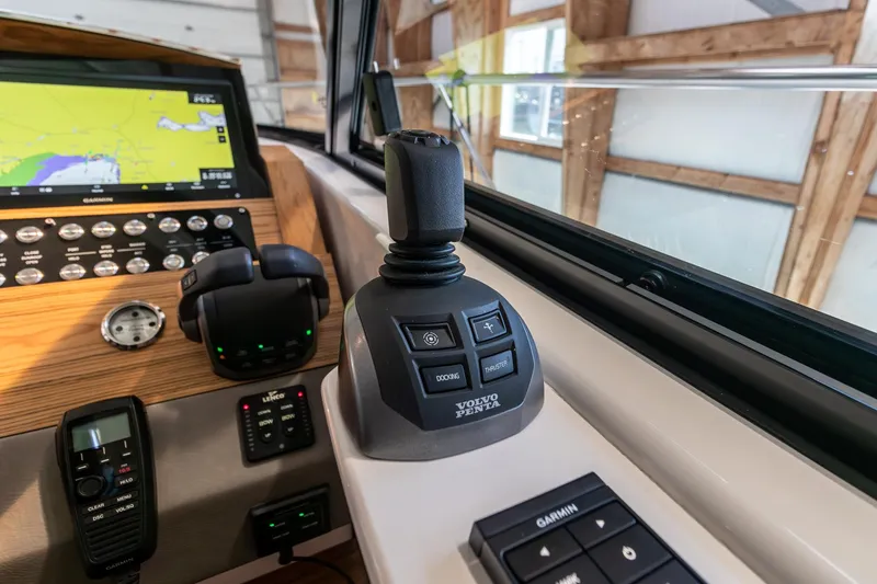 Slide: The Image of 2023 Tiara Yachts C44 Coupe helm with joystick control and navigation display. - 26