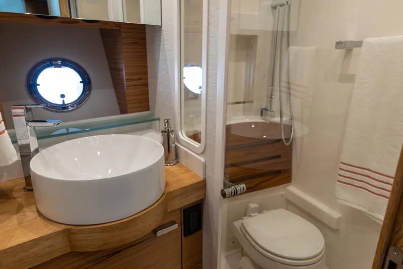 Slide: The Image of Luxurious bathroom in 2023 Tiara Yachts C44 Coupe, featuring modern sink and shower. - 30