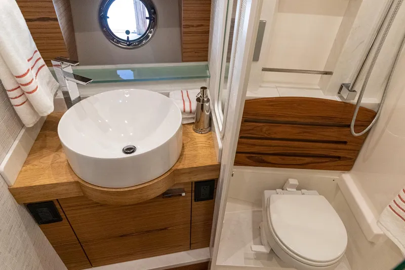 Slide: The Image of 2023 Tiara Yachts C44 Coupe bathroom with modern sink, toilet, and shower. - 31