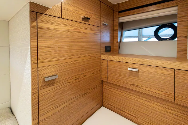 Slide: The Image of 2023 Tiara Yachts C44 Coupe interior with sleek wooden cabinetry and modern design. - 35