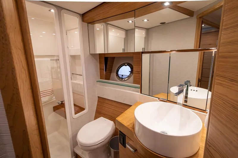 Slide: The Image of Luxurious bathroom in 2023 Tiara Yachts C44 Coupe with modern fixtures and wood accents. - 36